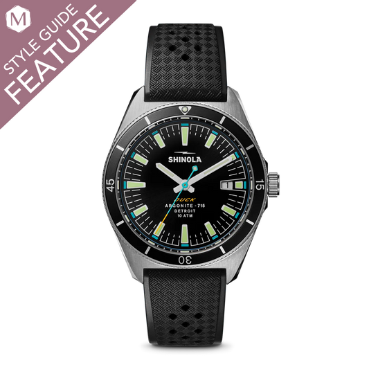 Black dial watch with rubber strap.