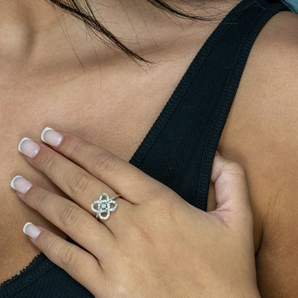 Diamond knot ring on hand.
