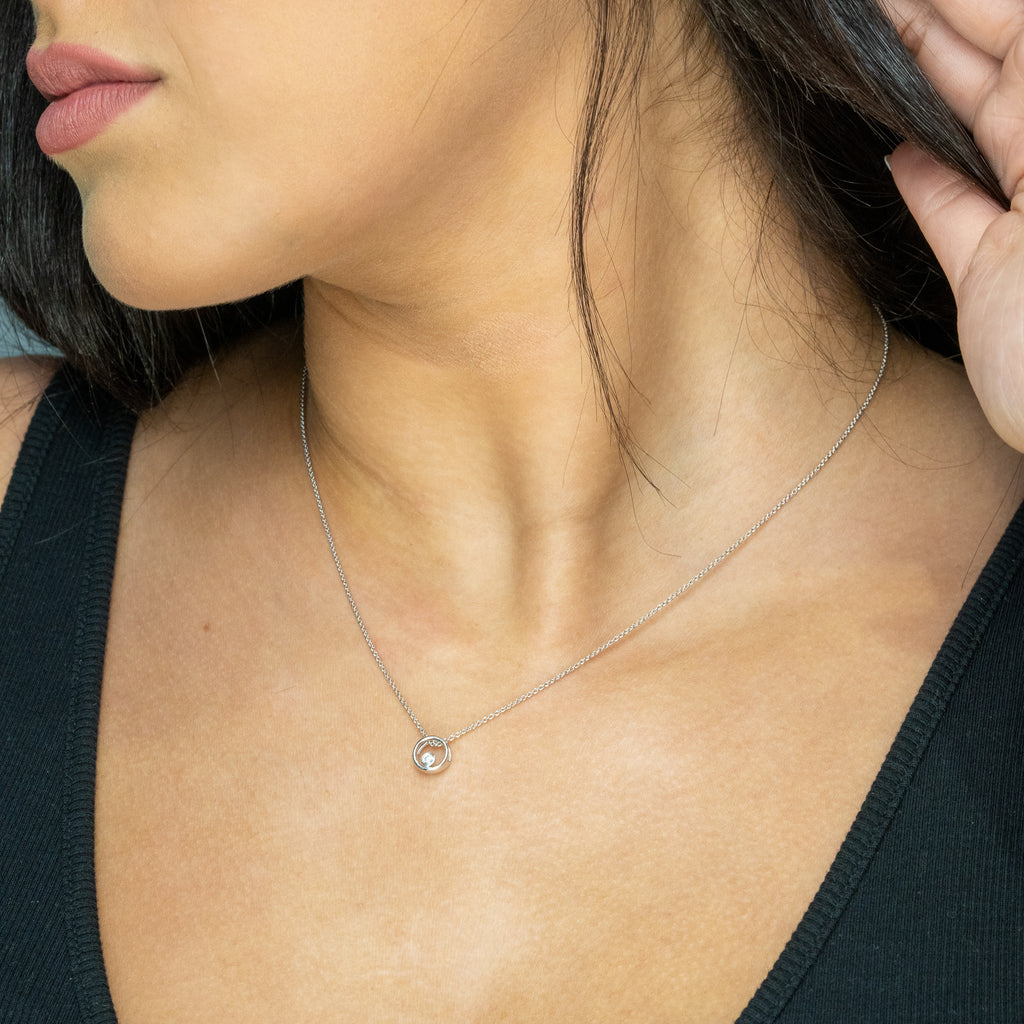 Sterling silver diamond circle pendant necklace.