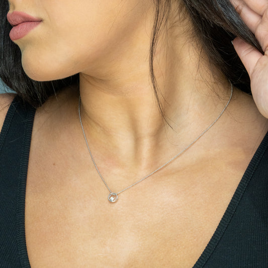 Sterling silver diamond circle pendant necklace.