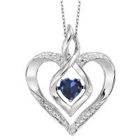 Sterling silver heart pendant with ruby centerpiece.