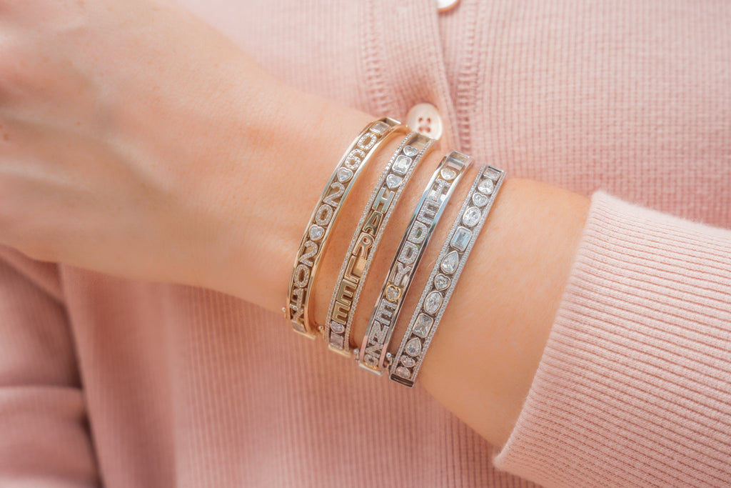 Gold and silver personalized charm bangles.