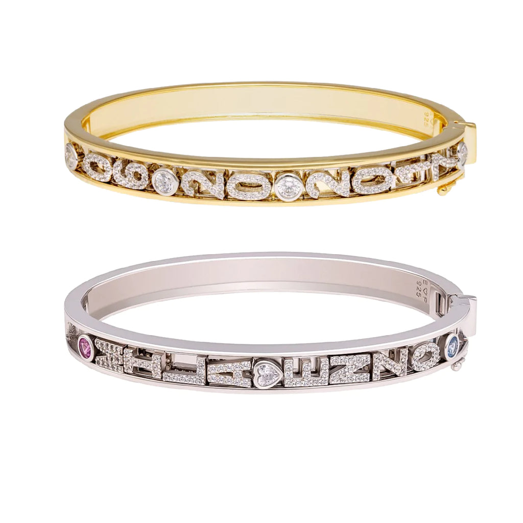 Gold and silver charm bangles with letters.