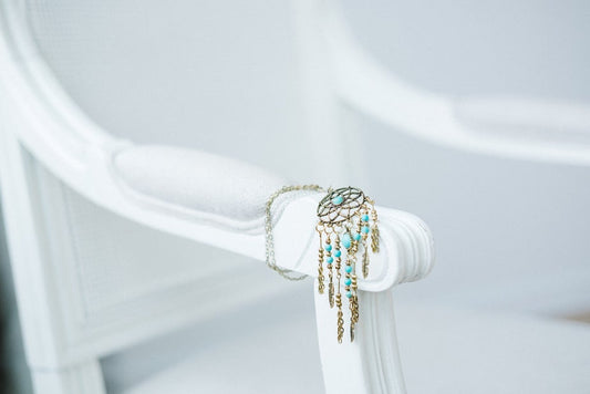 Turquoise dreamcatcher necklace with silver feathers.