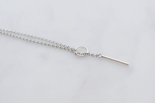 Sterling silver chain with circular pendant.